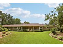 Charming single-story home featuring a covered front porch and a meticulously landscaped front yard at 202 Heights Pl, Canton, GA 30114
