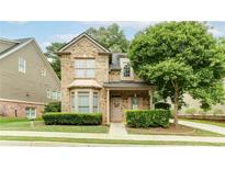 Charming brick two-story home with a landscaped front yard and inviting front porch at 4084 Fort Sumter Nw Lndg, Acworth, GA 30101
