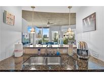 Granite counters accent this condo kitchen with views from the sink at 855 Peachtree Ne St # 501, Atlanta, GA 30308