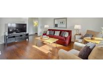 Cozy living room featuring hardwood floors, comfortable seating, and a modern entertainment center at 215 Piedmont Ne Ave # 1406, Atlanta, GA 30308