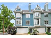 Charming townhome featuring bay windows, a two-car garage, and inviting curb appeal at 1912 Hosea L Williams Ne Dr # 1, Atlanta, GA 30317