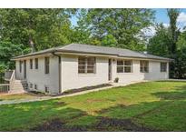 Charming one-story home with a well-maintained lawn and a neatly landscaped yard at 3422 Maplehurst Dr, Decatur, GA 30032
