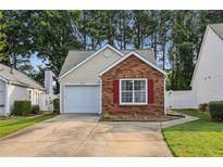 Charming single-story home featuring a brick facade, attached garage, and well-maintained landscaping at 2657 Albion Farm Way, Duluth, GA 30097