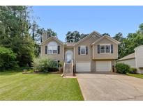 Charming two-story home with a well-maintained lawn, two-car garage and inviting front porch at 503 Silver Maple Ln, Woodstock, GA 30189
