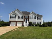 Charming two-story home with a well-manicured lawn and a two-car garage at 132 Peggy Meadows Way, Douglasville, GA 30134