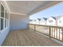Relaxing back porch featuring wood flooring, modern railings, and views of the neighborhood at 1996 Deco Dr, Kennesaw, GA 30144