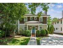 Charming two-story home with brown shingle and light-green siding, complemented by a well-manicured front yard at 261 Elmira Ne Pl, Atlanta, GA 30307