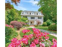 Charming two-story home with a manicured front yard and beautiful flower beds at 235 The Prado N, Atlanta, GA 30309