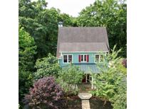 Charming two-story home with a well-manicured lawn and lush landscaping at 453 Carter Se Ave, Atlanta, GA 30317