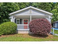 Charming single-story home with a welcoming front porch and well-maintained landscaping at 211 Margaret St, Fairburn, GA 30213