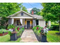 Charming home with a landscaped front yard, inviting entrance, and a cozy front porch at 486 Haas Se Ave, Atlanta, GA 30316