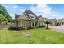 Charming single-Gathering home with a stone facade, manicured lawn, and an inviting entrance at 2855 Middlecreek Way # 2855, Cumming, GA 30041