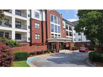 Beautiful exterior view of the building with well maintained landscaping and covered entrance with a brick facade at 3275 Lenox Ne Rd # 110, Atlanta, GA 30324