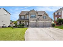 Stately brick home with a three-car garage, manicured lawn, and inviting curb appeal at 4854 Cathedral Ct, Powder Springs, GA 30127