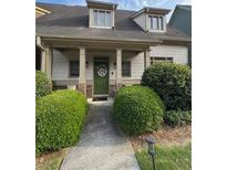 Charming home with a covered front porch, manicured landscaping, and a welcoming green front door at 2535 Village Creek Lndg, Atlanta, GA 30316