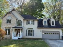 Charming two-story home featuring a brick accent, a covered entryway, and an attached two-car garage at 311 Indus Ln, Lawrenceville, GA 30044