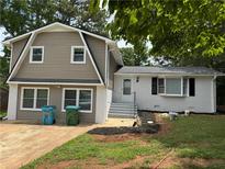 Charming two-story home with neutral siding and modern windows at 1094 Amber Sw Rdg, Lilburn, GA 30047