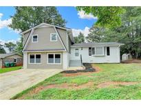 Charming two-story home featuring mixed siding and a well-maintained front yard in a neighborhood setting at 1094 Amber Sw Rdg, Lilburn, GA 30047