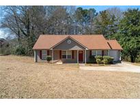 Charming single-story home with red brick accents, a cozy front porch, and a well-maintained lawn at 131 Tye St, Stockbridge, GA 30281