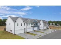 New construction townhomes with attached garages and modern architectural details at 52 Leggett Dr # 185, Villa Rica, GA 30180