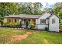 Charming one-story home with stone accents, wood shutters, and a well-manicured lawn at 3927 Airline Rd, Mcdonough, GA 30252