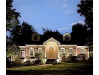 Charming brick home with dormers, illuminated entry, and beautifully landscaped front yard at 1821 N Rock Springs Ne Rd, Atlanta, GA 30324