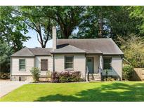 Charming brick home with a well-manicured lawn and lush greenery at 103 Willow Wood Se Cir, Atlanta, GA 30317