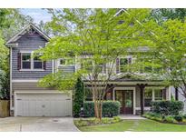 Charming two-story home boasts beautiful landscaping, a two-car garage, and a welcoming front porch at 2544 Thompson Ne Rd, Brookhaven, GA 30319