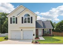 Charming two-story home with a two-car garage and well-maintained front yard at 7033 Brecken Trce, Lithonia, GA 30058