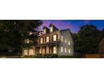 Stunning two-story home boasts a brick facade, inviting porch, and lush landscaping at 7601 Watson Cir, Locust Grove, GA 30248