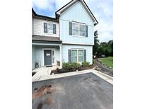 Charming two-story home with light blue siding, gray shutters, and a welcoming front entrance at , Covington, GA 30014