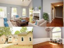 Bright living room boasts a fireplace, vaulted ceilings, and large windows at 1252 Heritage Dr, Villa Rica, GA 30180