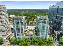Stunning aerial view of luxury high-rise condos with a pool and beautiful green surroundings at 943 Peachtree Ne St # 2001, Atlanta, GA 30309