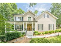 Charming home with a welcoming front porch and beautifully landscaped front yard at 3440 Canyon Oak Way, Cumming, GA 30041