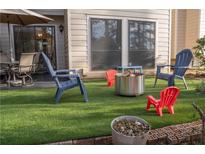 Outdoor patio with comfortable seating, artificial grass, and a fire pit, perfect for entertaining at 4846 Twin Lakes Trl, Atlanta, GA 30360