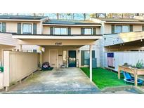 Townhome exterior with covered parking and lovely landscaping features at 4846 Twin Lakes Trl, Atlanta, GA 30360