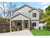 Charming two-story home with gray siding, white trim, inviting front porch, and a well-manicured front yard at 1521 Sylvan Sw Rd, Atlanta, GA 30310