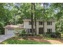 Charming two-story home with beautiful landscaping and a two-car garage at 5240 Arrie Way, Atlanta, GA 30360