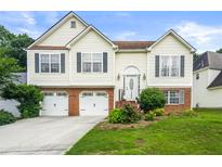 Charming two-story home featuring a well-maintained lawn and an attached two-car garage at 3485 Palisade Lake Dr, Duluth, GA 30096
