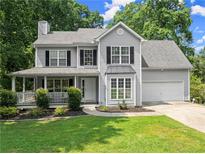 Charming two-story home with a covered porch and a well-manicured lawn, perfect curb appeal at 5510 Pilgrim Point Ext, Cumming, GA 30041