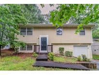 Charming two-story home with stone accents, a neatly maintained lawn, and a welcoming entrance at 2139 Jonathan Ave, Lithonia, GA 30058