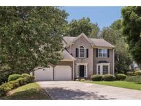Charming two-story home with attached two car garage and well-maintained landscaping at 3850 Stepney Way, Cumming, GA 30041