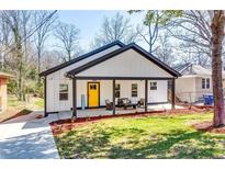 Charming renovated home featuring a covered front porch and a bright yellow door at 236 Barfield Sw Ave, Atlanta, GA 30310
