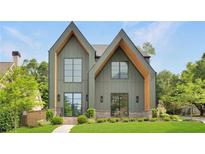 Stunning home showcasing modern design, a well-kept lawn, and meticulously landscaped grounds at 504 Barrington Drive, Roswell, GA 30075