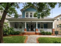Charming two-story home featuring a spacious front porch, lush landscaping, and classic architectural details at 1038 Saint Charles Ave, Atlanta, GA 30306