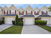 Charming townhome with a one-car garage, manicured lawn and red window shutters at 6962 Gallant Circle Southeast Se Cir # 24, Mableton, GA 30126