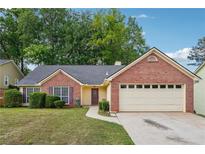 Charming single Gathering home with a manicured front yard and an attached two car garage, perfect for any Gathering at 1921 Flint Hill Dr, Lawrenceville, GA 30044