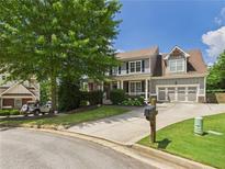 Beautiful two-story home with a three car garage, lush landscaping and a welcoming driveway at 122 White Spruce Ct, Dallas, GA 30157