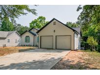 View of the home's exterior, highlighting the two-car garage and driveway at 515 Allens Landing Ct, Lawrenceville, GA 30045