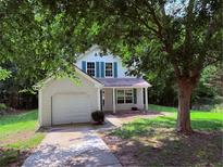 Charming home with attached garage and a well-maintained front yard at 7250 Bridgeport Ct, Austell, GA 30168